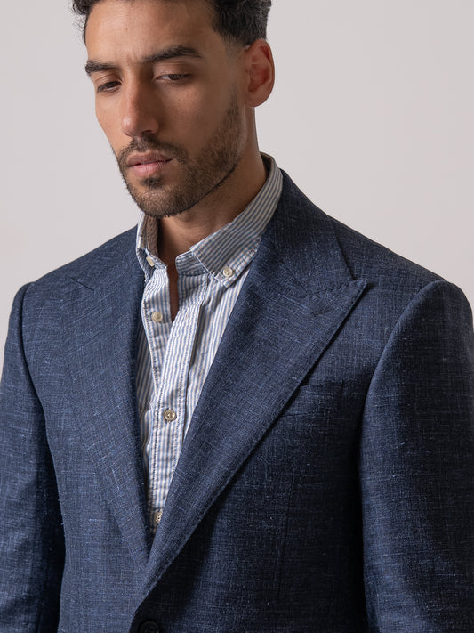 Close-up of the wide peak lapel on a light blue linen-wool blazer