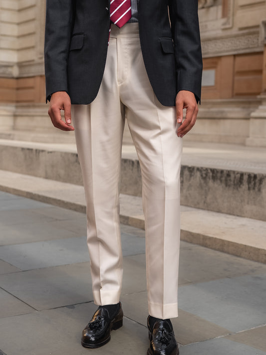 White trousers paired with a dark grey sharkskin blazer