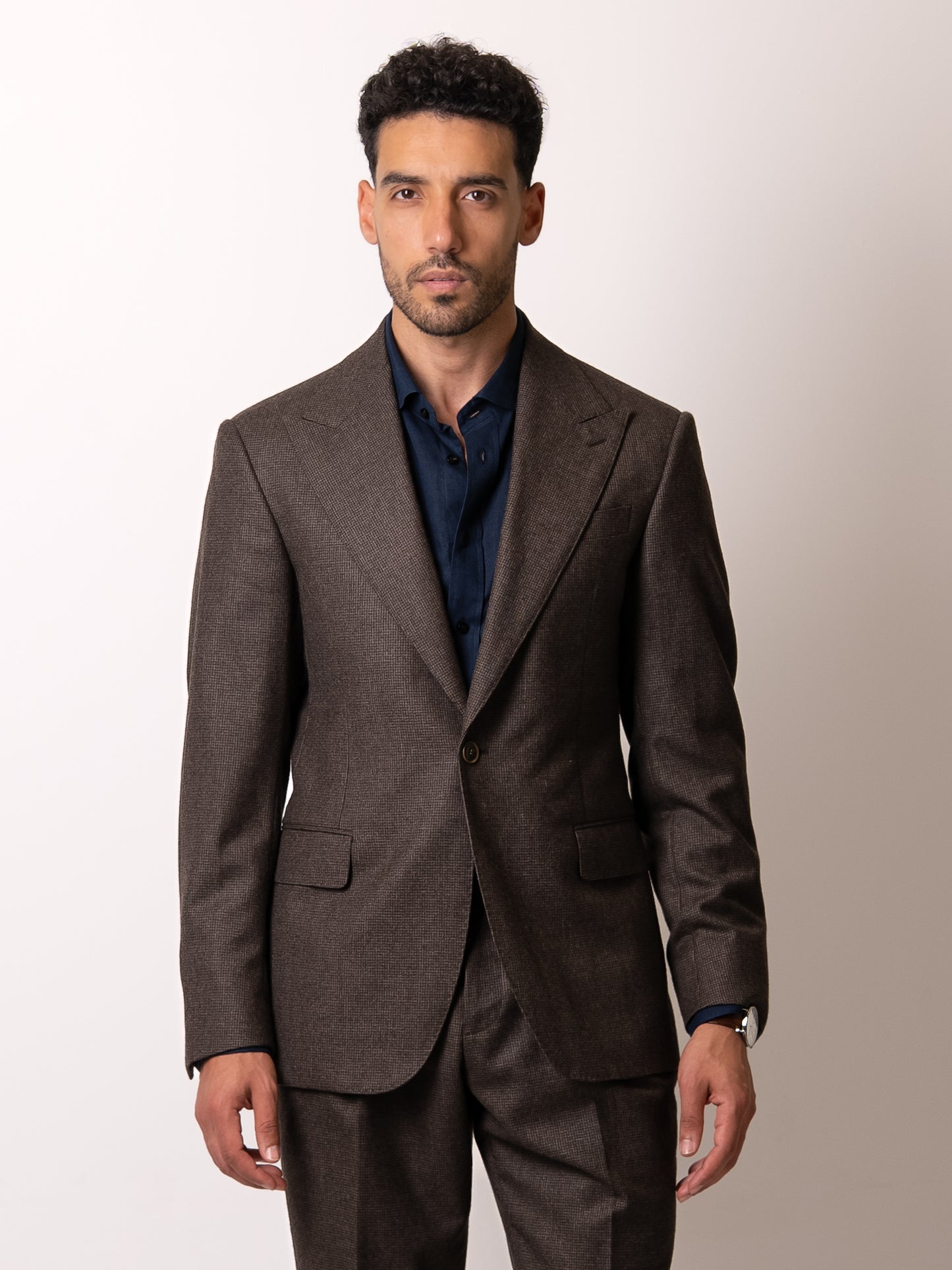 Front view of the tailored deep brown houndstooth blazer — single-button closure