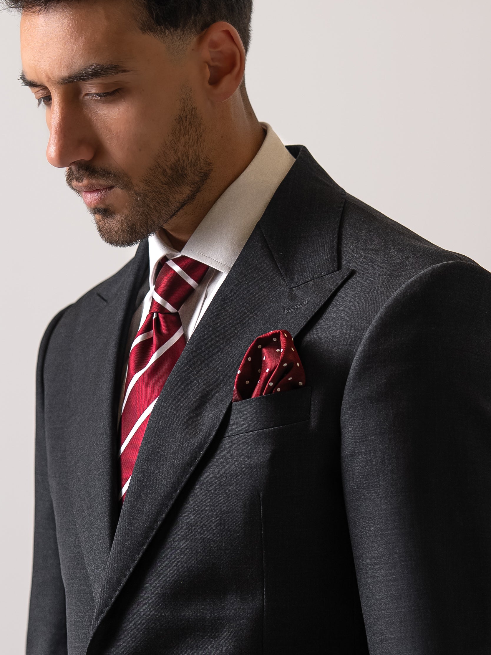 Close-up of functional wide peak on a dark sharkskin grey suit. A hallmark of true tailoring, precision, and understated craftsmanship. 