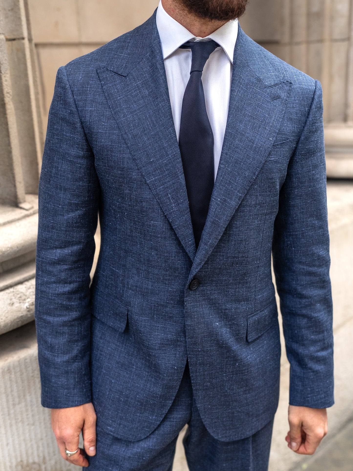 Close-up of the wide peak lapel on the made-to-measure light blue linen-wool blazer 