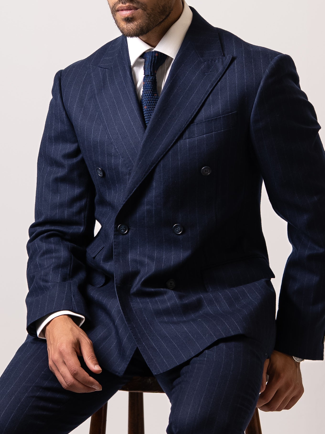 Chalk stripe double-breasted blazer with wide peak lapels, six-button closure, and structured shoulders . Crafted for timeless command and modern elegance. 
